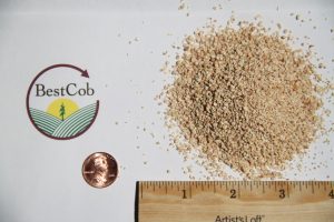 Close-up of granular soil sample with BestCob logo and ruler for scale.