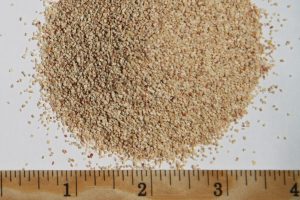 Close-up of Best Cob organic soil amendment with a ruler for scale.
