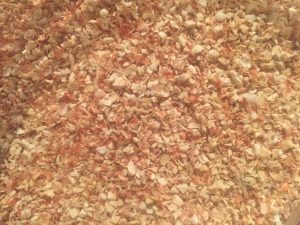 Close-up of dried corn cob pieces for animal feed and livestock nutrition.