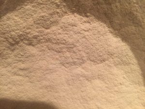 Close-up of white powdered substance, possibly flour or baking ingredient.