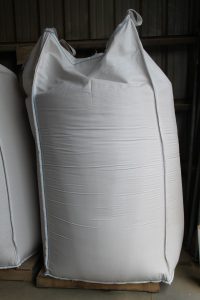 Large white bulk bag for industrial use with lifting loops at the top.
