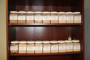 Shelf with various jars of cob and seed mixes for best cob products.