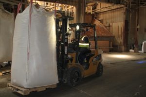 Forklift moving large bag of cob in industrial warehouse for Best Cob.