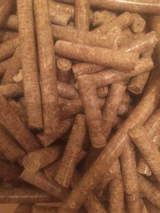 Close-up of brown animal feed pellets for livestock nutrition.
