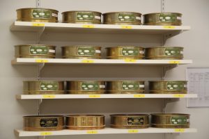 Assorted tins of Best Cob products displayed on store shelves.
