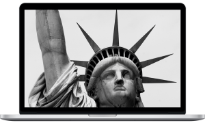 Close-up of the Statue of Liberty's face and crown in black and white.