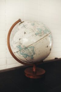 Decorative globe on wooden stand showcasing world map for education and office decor.