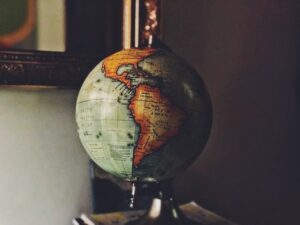 Small globe showing South America and Africa with a dark background.