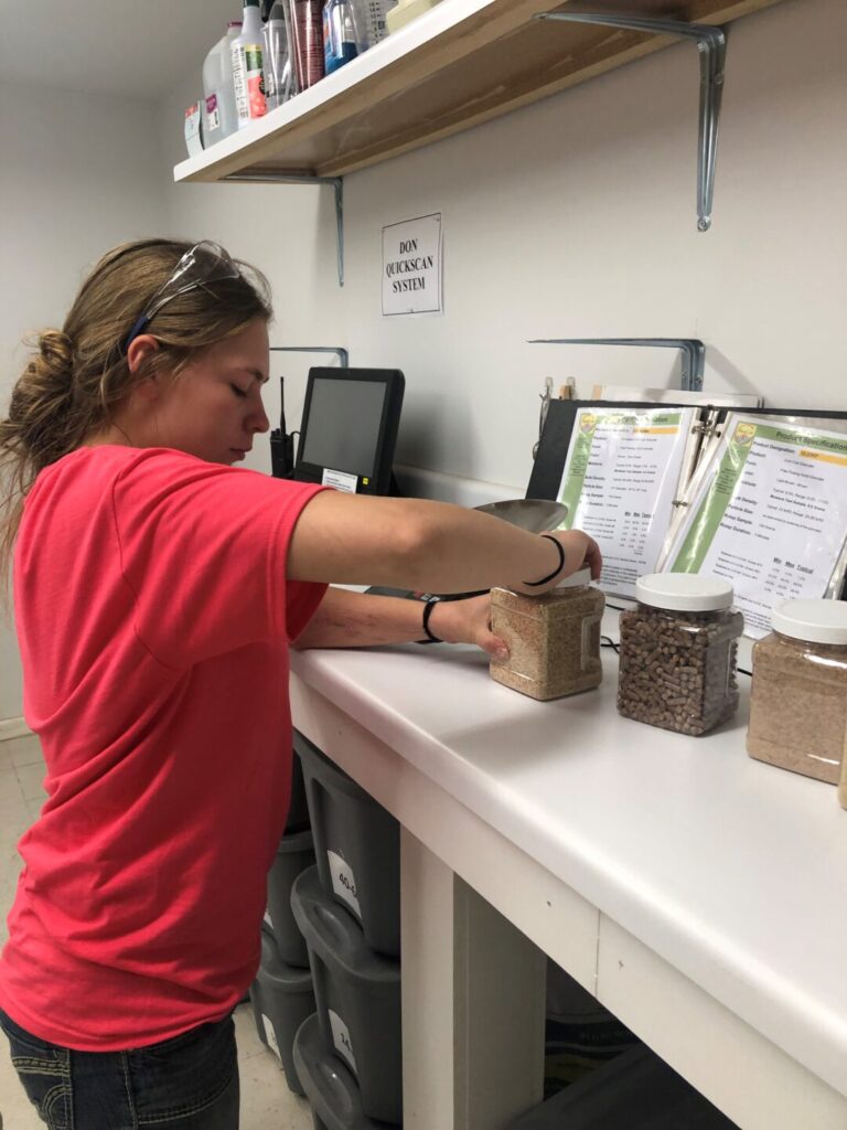 Young woman selecting cob samples at Best Cob for quality testing.