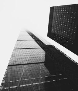 Modern glass skyscrapers with reflective surfaces in a cityscape.