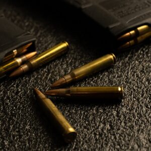 Close-up of brass bullet casings on textured black background for Best Cob.